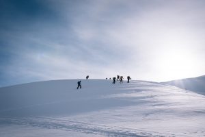 Ski tourers climbing a snowy slope in the mountains of Svaneti, Georgia